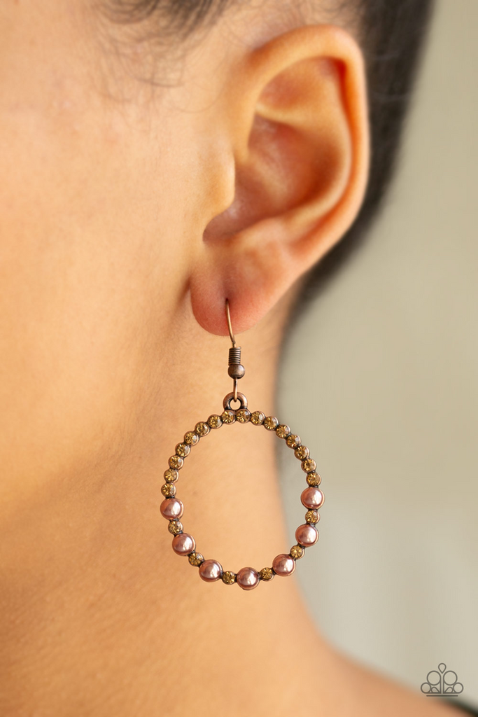 Encrusted in glassy topaz rhinestones, the bottom of a glistening copper hoop is dotted in bubbly copper pearls for a refined fashion. Earring attaches to a standard fishhook fitting.  Sold as one pair of earrings.