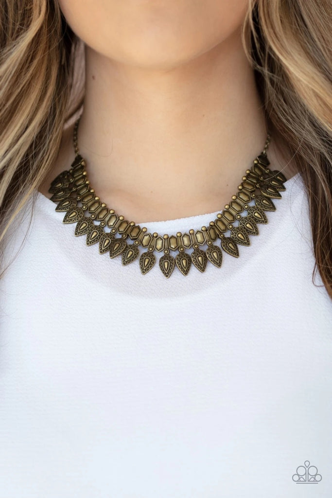 Attached to studded brass fittings, decorative brass teardrops alternate with hexagonal brass frames along an invisible wire, creating a bold tribal inspired fringe below the collar. Features an adjustable clasp closure.  Sold as one individual necklace. Includes one pair of matching earrings.