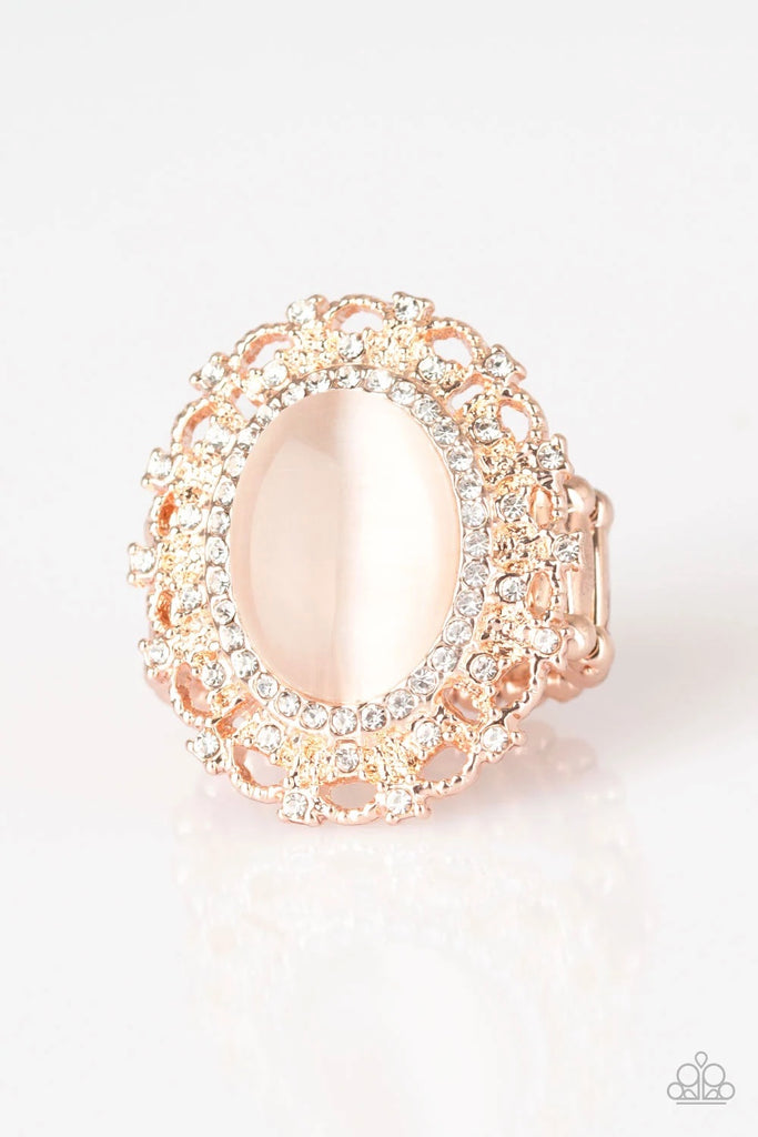 Encrusted in dainty white rhinestones, a frilly rose gold frame spins around a glowing moonstone center for a regal look. Features a stretchy band for a flexible fit.  Sold as one individual ring.  
