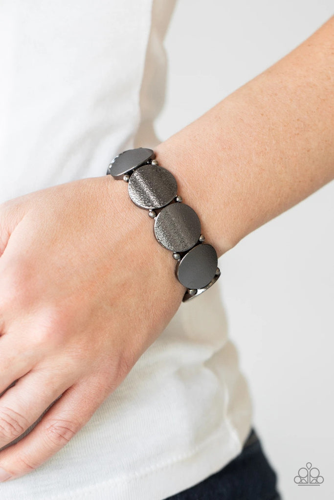 Infused with pairs of dainty gunmetal beads, delicately hammered gunmetal discs slide along a stretchy band around the wrist for a hint of industrial flavor.  Sold as one individual bracelet.