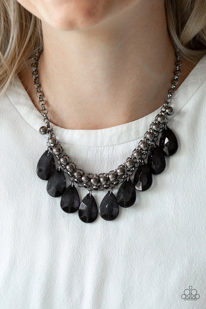 A row of glistening gunmetal beads gives way to glassy black teardrops, creating a bold tone on tone fringe below the collar. Features an adjustable clasp closure.  Sold as one individual necklace. Includes one pair of matching earrings.