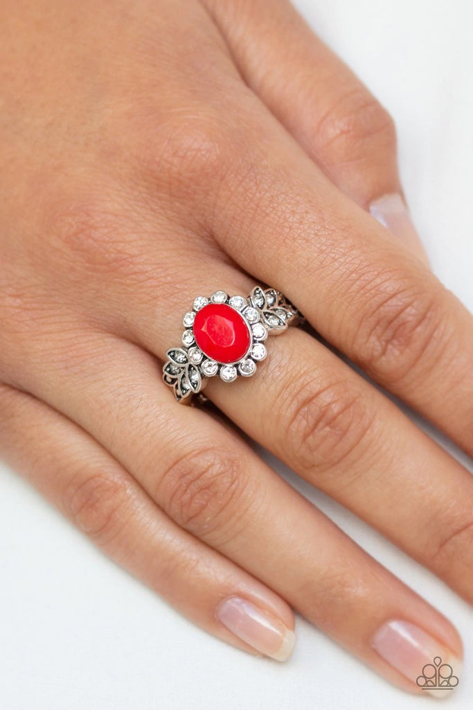 Encrusted in glittery white rhinestone petals, a dainty red bead is pressed into a leafy silver frame dazzling with white rhinestone accents. Features a dainty stretchy band for a flexible fit.  Sold as one individual ring.