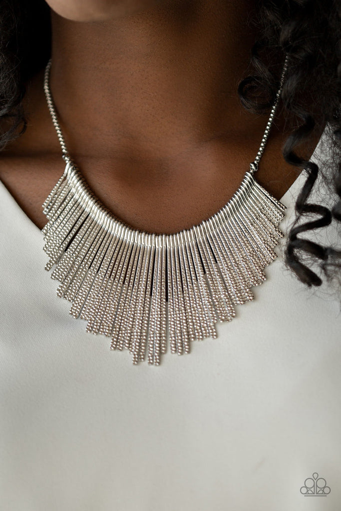 Textured silver rods flare out from the bottom of a rounded silver chain, creating a tapered fringe below the collar for a statement-making finish. Features an adjustable clasp closure.  Sold as one individual necklace. Includes one pair of matching earrings.