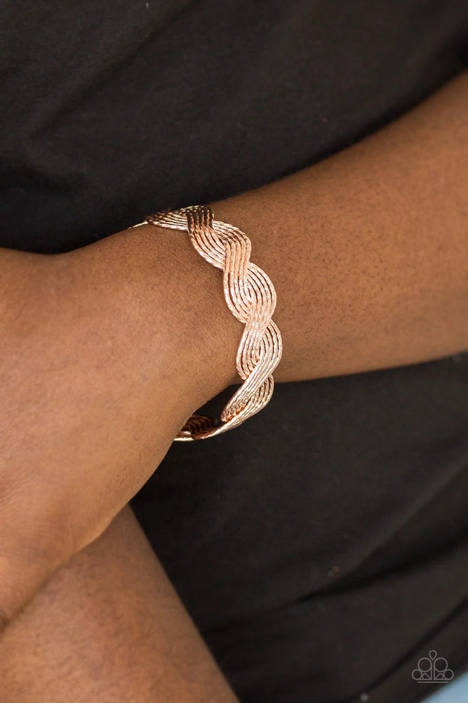 Delicately hammered in shimmery detail, glistening rose gold wires braid into a brilliant cuff around the wrist for a casual look.  Sold as one individual bracelet.  