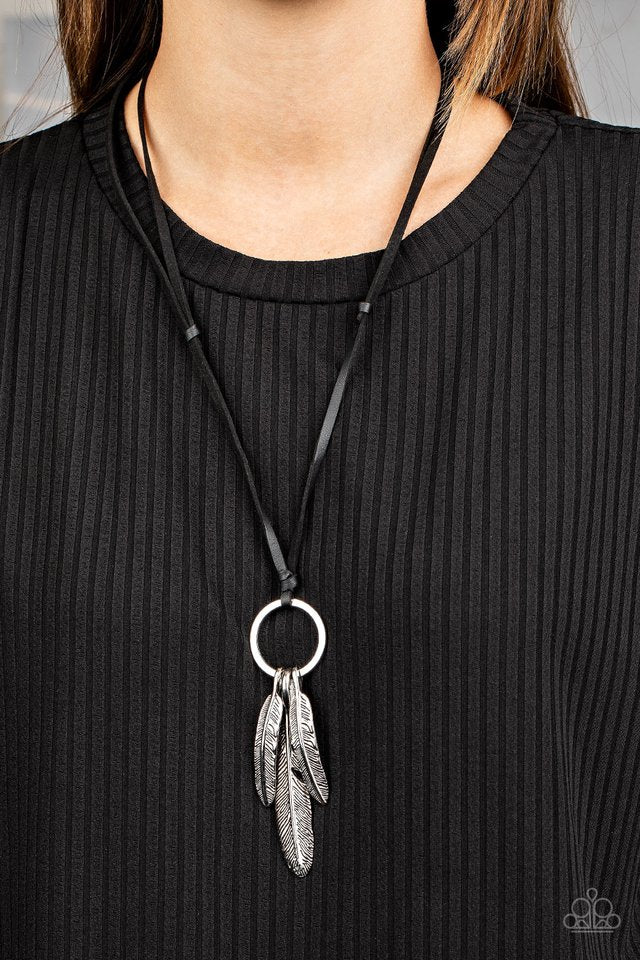 Mismatched silver feather charms glide along a silver ring at the bottom of an earthy piece of black leather cording, creating a rustic pendant. Features an adjustable sliding knot closure.  Sold as one individual necklace.