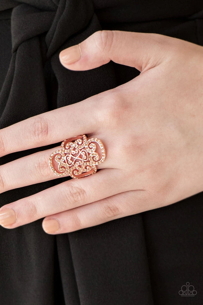 Dainty peach rhinestones are encrusted along a shiny copper frame radiating with regal filigree for a refined look. Features a stretchy band for a flexible fit.  Sold as one individual ring.