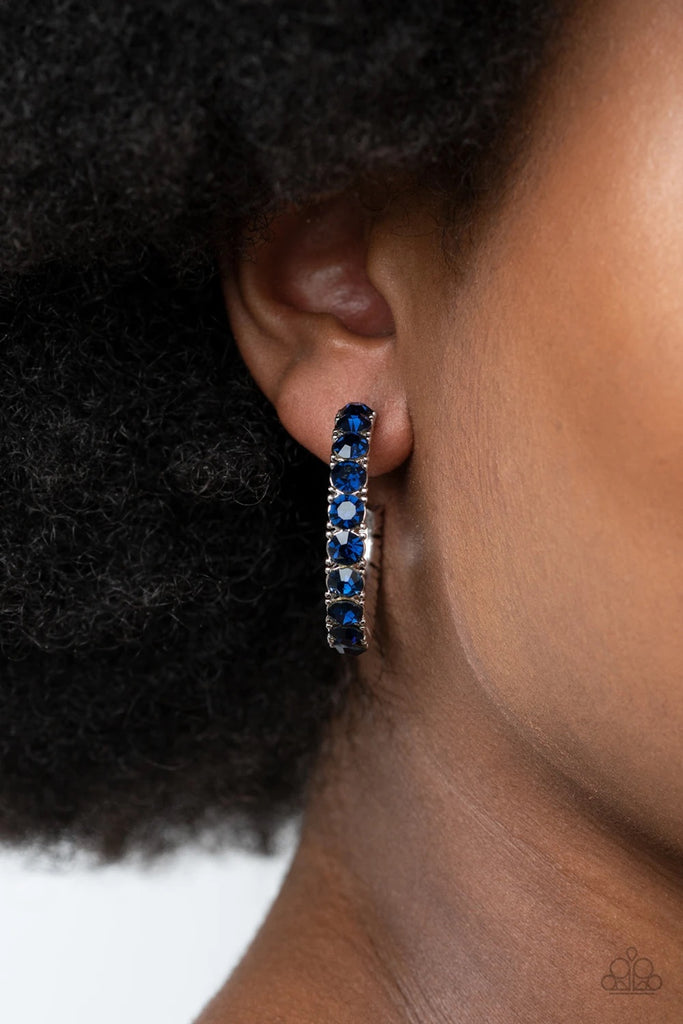 An oversized collection of glittery blue rhinestones are encrusted along a textured silver hoop, creating a glamorous sparkle. Earring attaches to a standard post fitting. Hoop measures approximately 1 1/2" in diameter.  Sold as one pair of hoop earrings.