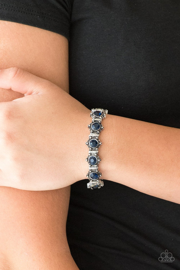 Featuring glittery blue rhinestone centers, ornate silver frames are threaded along stretchy bands, linking across the wrist for a refined look.  Sold as one individual bracelet.  