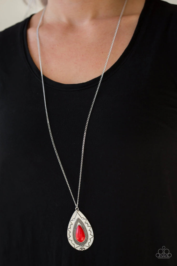 Chiseled into a tranquil teardrop, a fiery red stone is pressed into an ornate silver frame. The whimsical pendant swings from the bottom of a lengthened silver chain for a seasonal look. Features an adjustable clasp closure.  Sold as one individual necklace. Includes one pair of matching earrings.