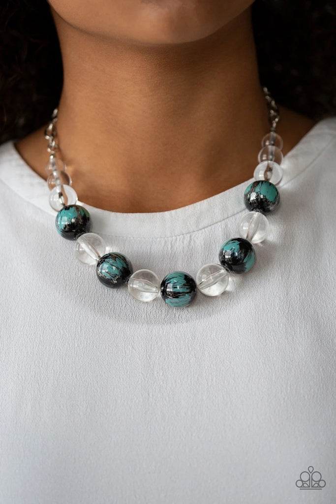 A collection of shiny black and glassy clear beads are threaded along an invisible wire below the collar. The black beads are splashed in hints of refreshing blue and shiny metallic paint for a colorful finish. Features an adjustable clasp closure.  Sold as one individual necklace. Includes one pair of matching earrings.