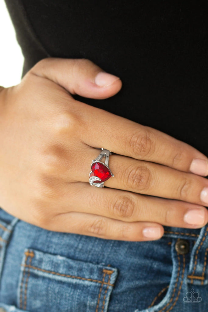 Infused with a dainty silver ribbon radiating with glassy white rhinestones, an oversized red heart-shaped rhinestone adorns the center of the finger for a romantic look. Features a dainty stretchy band for a flexible fit.  Sold as one individual ring.