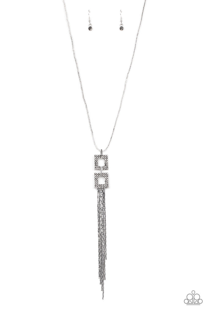 Encrusted in smoky hematite rhinestones, two squared, silver frames link at the bottom of a lengthened silver box chain. Flattened silver chains stream from the bottom of the stacked pendant, creating an edgy tassel. Features an adjustable clasp closure.  Sold as one individual necklace. Includes one pair of matching earrings.