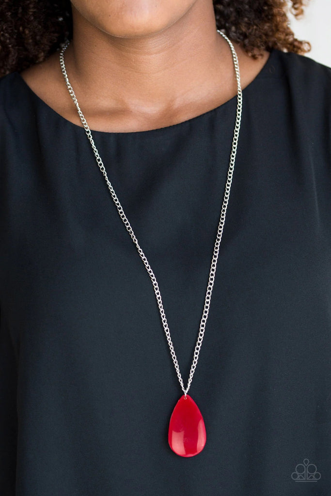 A robust red teardrop pendant swings from the bottom of a lengthened silver chain, adding a perfect pop of color to any outfit. Features an adjustable clasp closure.  Sold as one individual necklace. Includes one pair of matching earrings.