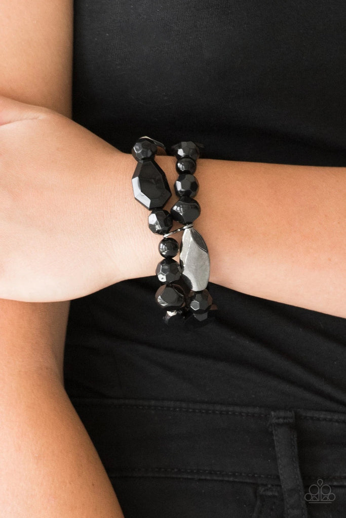 Mismatched gunmetal, polished black, and crystal-like beads are threaded along interlocking stretchy bands for a whimsical look.  Sold as one individual bracelet.  
