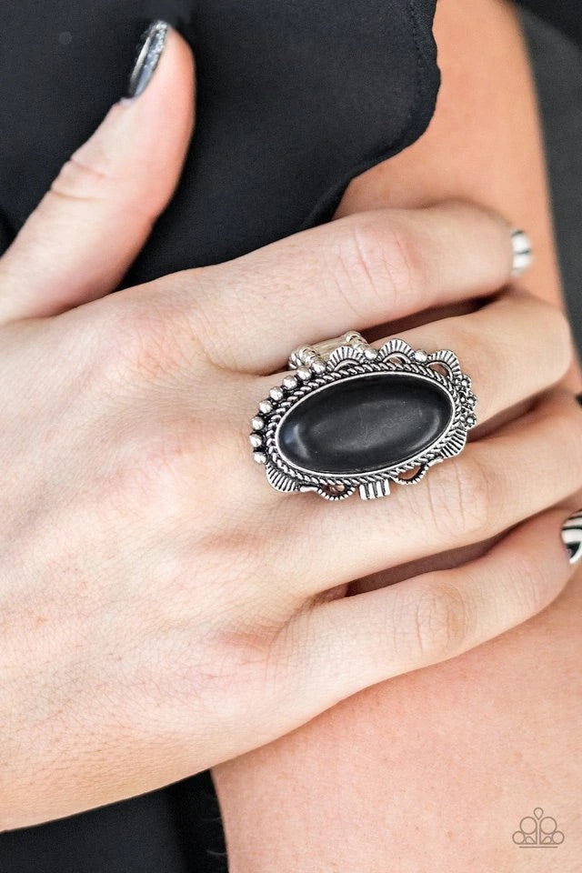 An earthy black stone is pressed into an ornate silver frame rippling with studded and serrated textures for a seasonal flair. Features a stretchy band for a flexible fit. Sold as one individual ring.