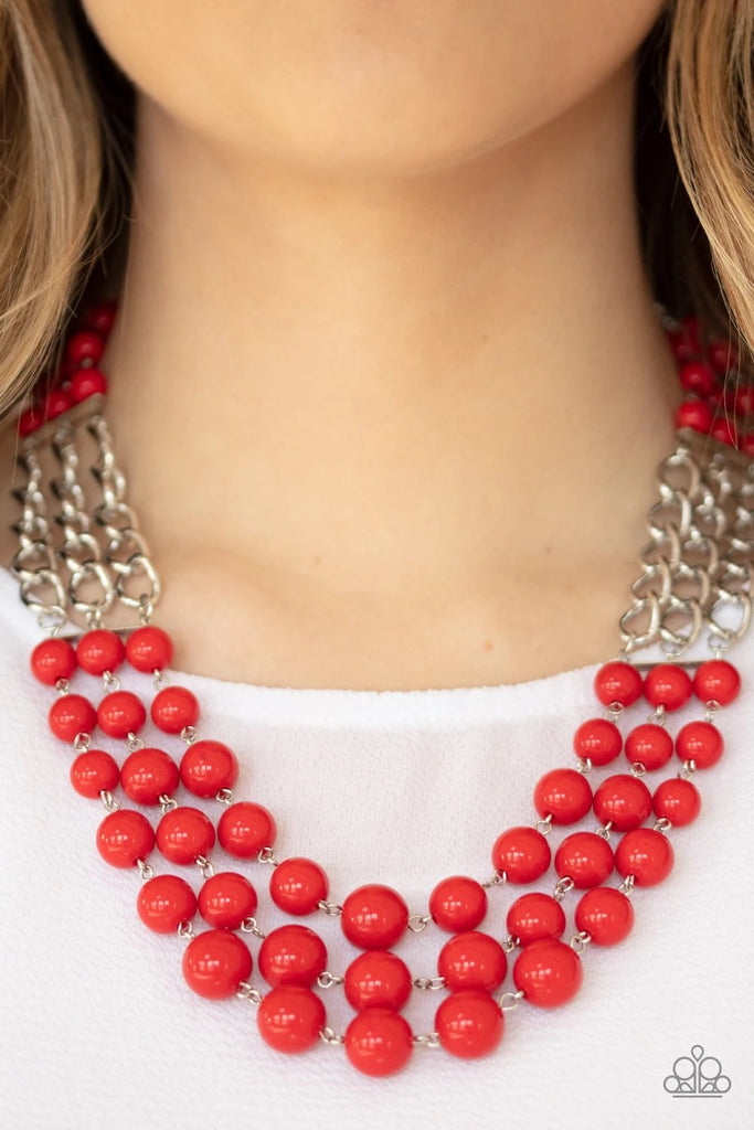 Sections of thick silver chains and bubbly red beaded rows layer below the collar, creating statement-making layers. Features an adjustable clasp closure.  Sold as one individual necklace. Includes one pair of matching earrings.