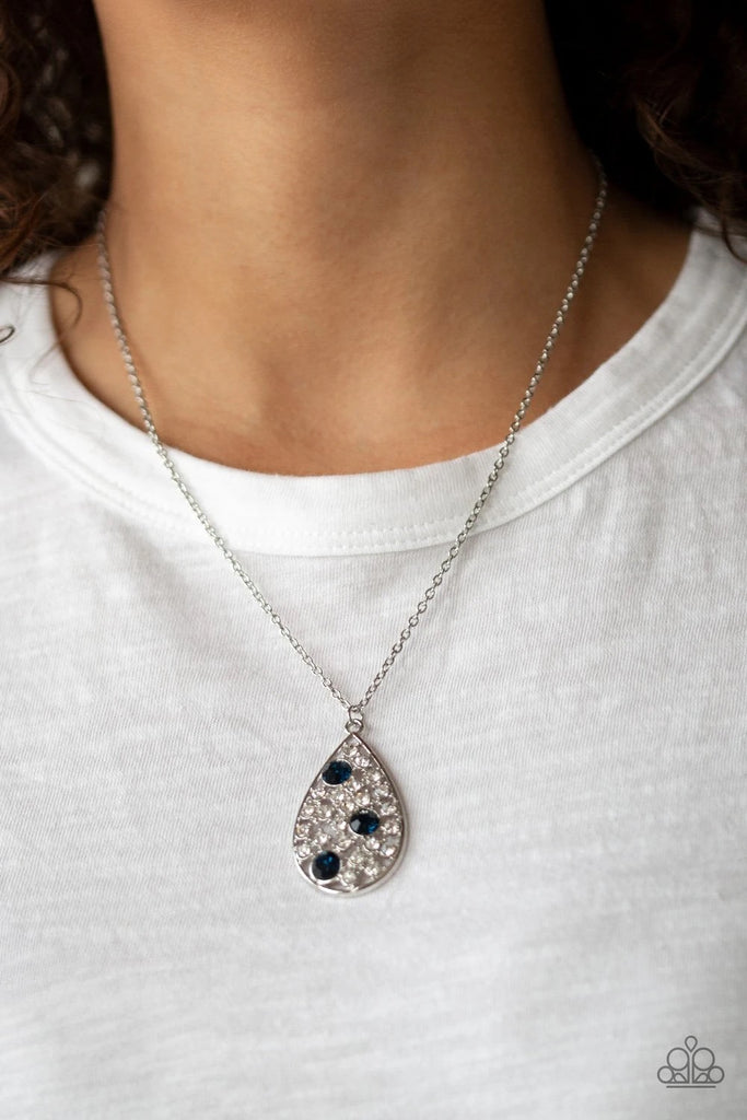 A collection of glassy white and glittery blue rhinestones coalesces inside a shimmery silver teardrop frame, creating a refined pendant. Features an adjustable clasp closure.  Sold as one individual necklace. Includes one pair of matching earrings.