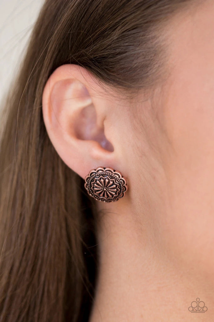 Embossed in a whimsical floral pattern, a glistening copper frame dots the ear for a seasonal look. Earring attaches to a standard post fitting.  Sold as one pair of post earrings.