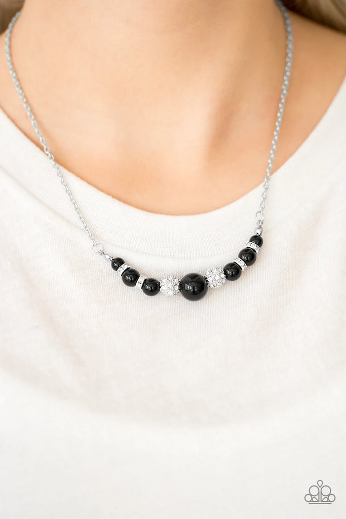 Encrusted in glassy white rhinestones, sparkling silver beads and polished black beads are threaded along a wire, creating a refined pendant below the collar. Features an adjustable clasp closure.  Sold as one individual necklace. Includes one pair of matching earrings.
