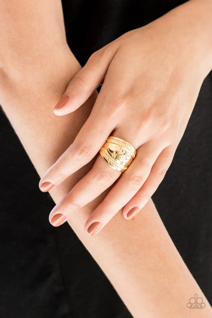 Ribbons of circular texture are embossed along the borders of a hammered gold band for an edgy look. Features a stretchy band for a flexible fit.  Sold as one individual ring. 