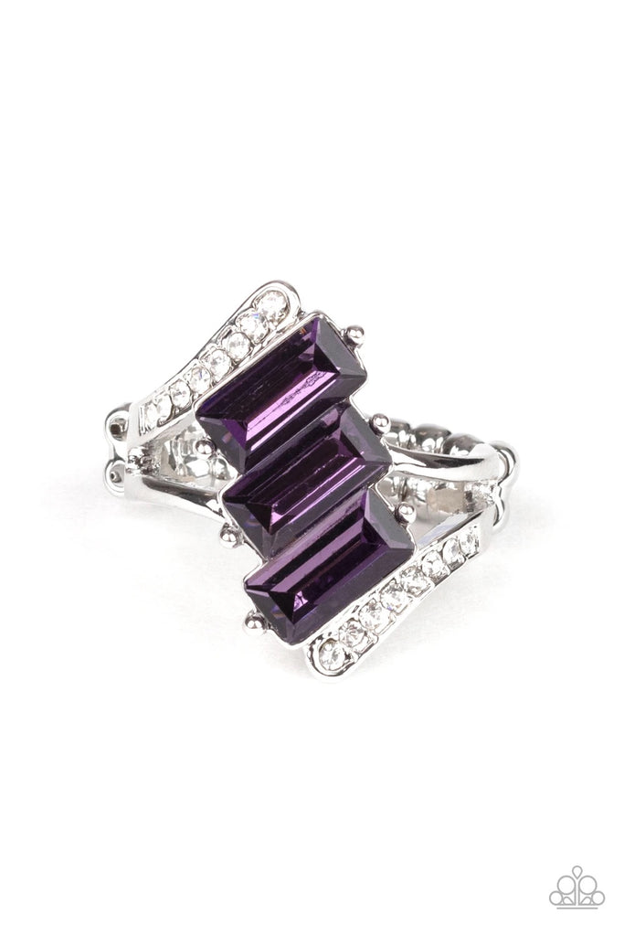 Nestled between two dazzling white rhinestone encrusted silver fittings, three emerald cut purple rhinestones slant across the finger for a glamorous look. Features a dainty stretchy band for a flexible fit.  Sold as one individual ring.