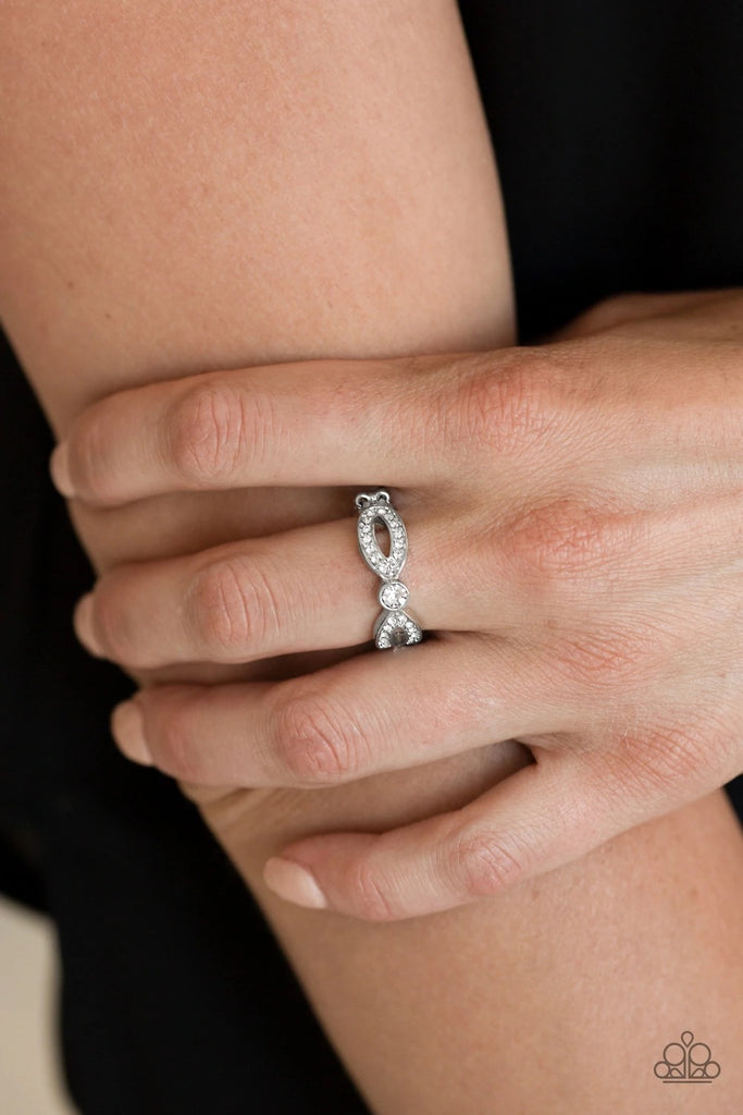 Encrusted in glassy white rhinestones, glistening silver ribbons loop away from a dazzling white rhinestone center for a refined look. Features a dainty stretchy band for a flexible fit.  Sold as one individual ring.