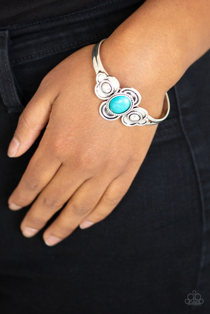 A refreshing turquoise stone is pressed into the center of a dainty silver cuff radiating with textured silver frames for a seasonal look.  Sold as one individual bracelet.  