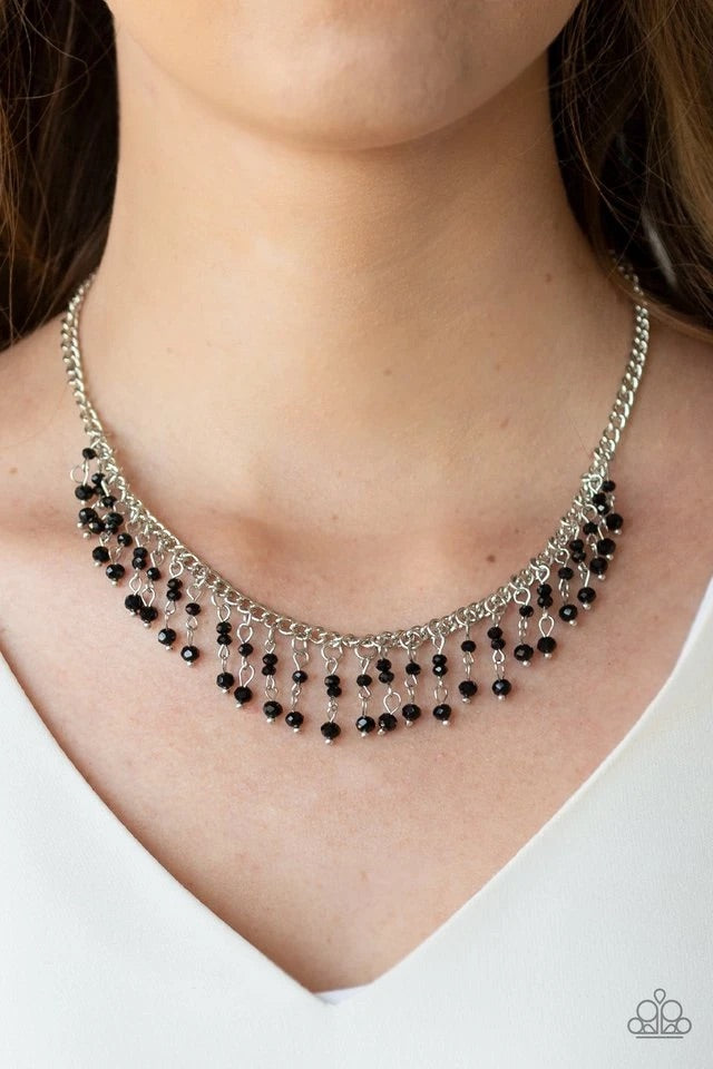 A collection of dainty black crystal-like beads are threaded along stacks of metallic rods, creating a twinkling fringe below the collar. Features an adjustable clasp closure. Sold as one individual necklace. Includes one pair of matching earrings.