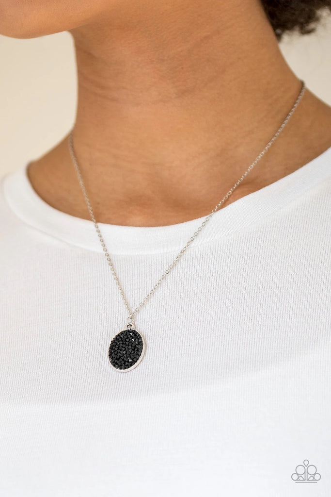Glittery black rhinestones are sprinkled along an oval silver frame, creating a stellar pendant below the collar. Features an adjustable clasp closure.  Sold as one individual necklace. Includes one pair of matching earrings.