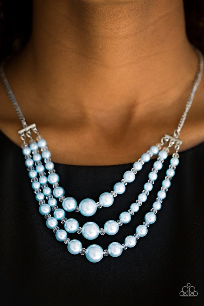 Varying in size, three strands of timeless blue pearls swing from the bottom of a shimmery silver chain. Dainty crystal-like beads are sprinkled between the pearl accents, adding classic shimmer to the elegant palette. Features an adjustable clasp closure.  Sold as one individual necklace. Includes one pair of matching earrings.