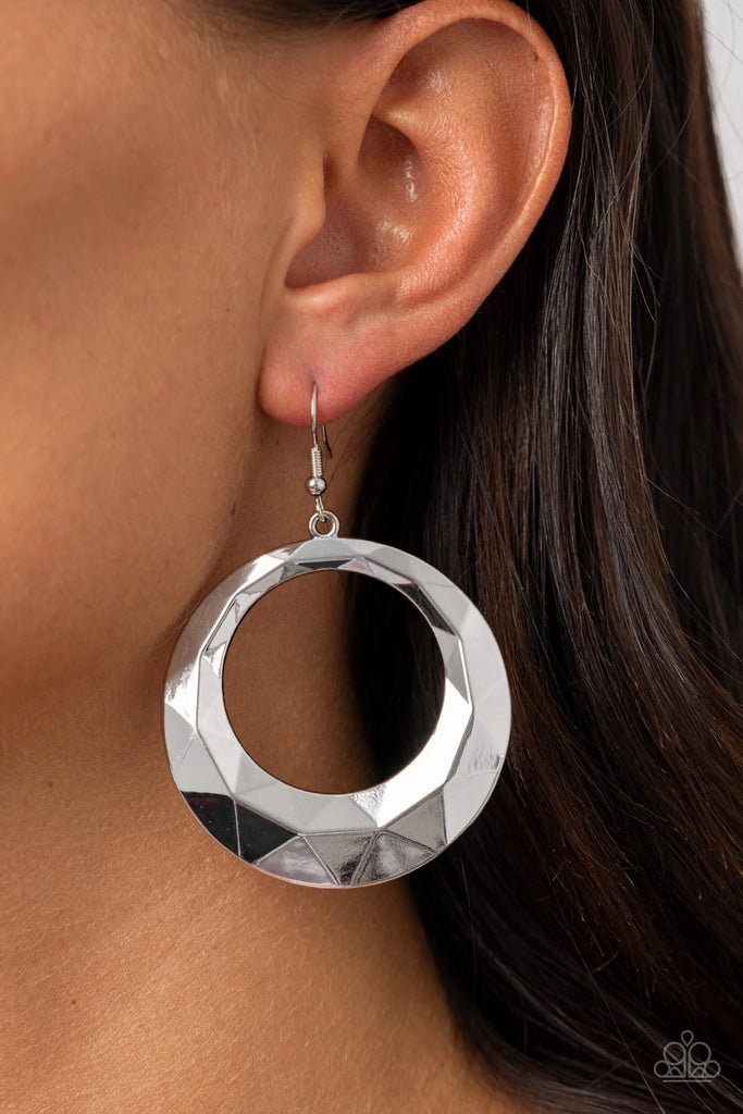 Faceted in light-reflecting textures, a beveled silver hoop swings from the ear for an edgy shine. Earring attaches to a standard fishhook fitting.  Sold as one pair of earrings.  