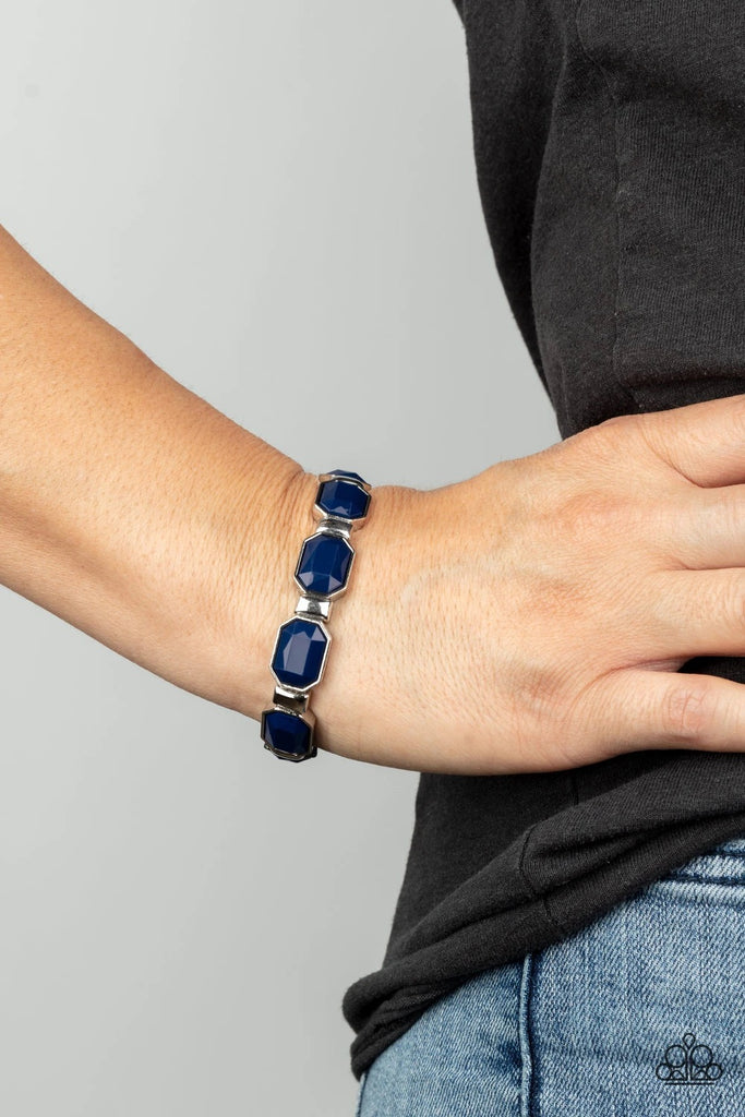 Encased in sleek silver fittings, faceted blue beads join dainty silver rectangular frames along stretchy bands around the wrist for a dainty pop of color.  Sold as one individual bracelet.