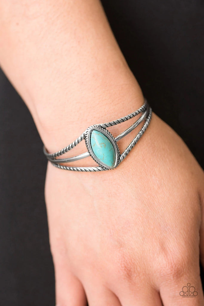 Chiseled into a tranquil marquise cut, a refreshing turquoise stone is pressed into a textured silver cuff for a seasonal look.  Sold as one individual bracelet.  