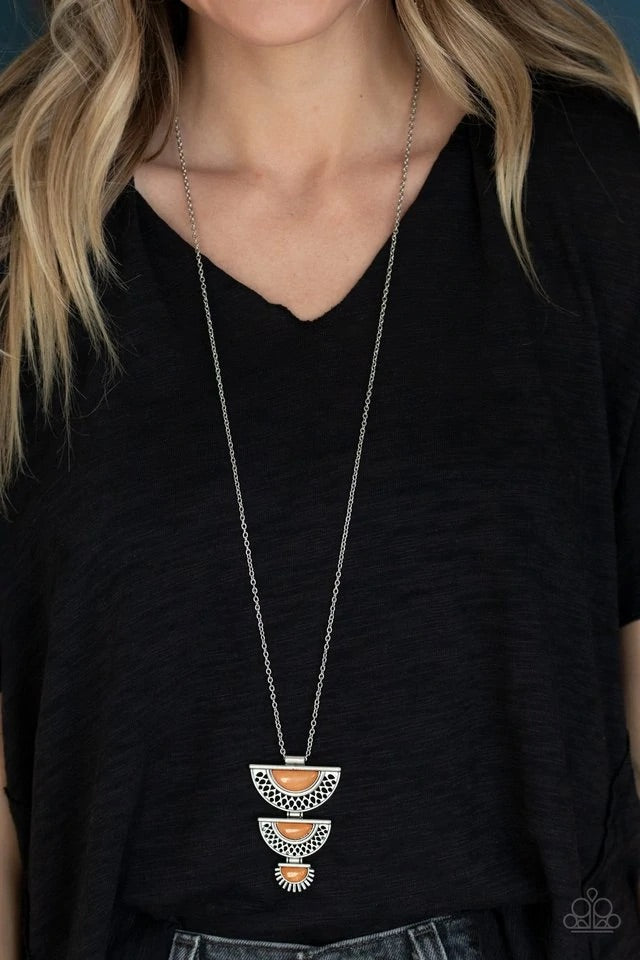 Featuring orange stone centers, decorative half-moon silver frames stack at the bottom of a lengthened silver chain for a whimsical look. Features an adjustable clasp closure. Sold as one individual necklace. Includes one pair of matching earrings.
