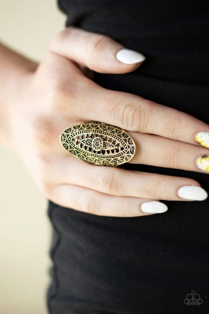 Radiating with studded filigree, an ornate brass oval folds around the finger for a bold tribal look. Features a stretchy band for a flexible fit.  Sold as one individual ring.