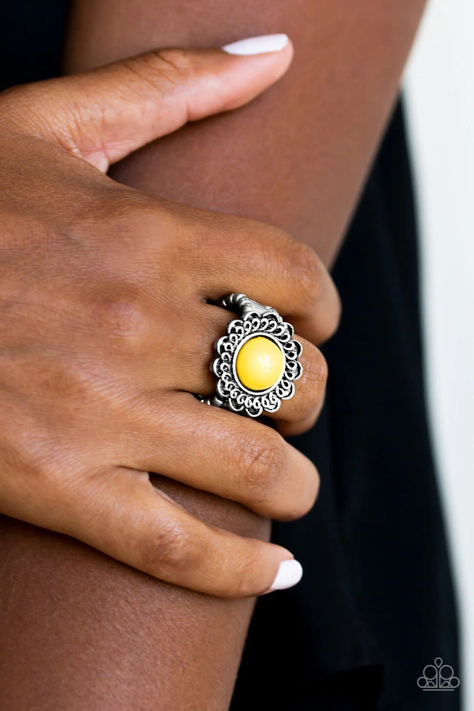 A sunny yellow bead is pressed into the center of a shimmery floral frame radiating with swirling detail. Features a stretchy band for a flexible fit.  Sold as one individual ring.  