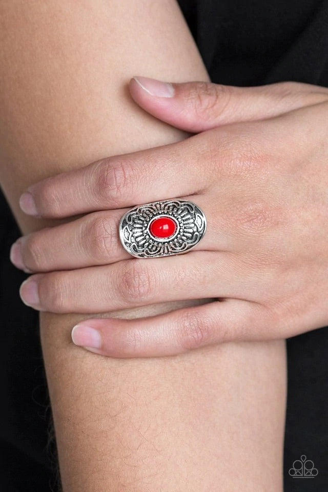 A fiery red bead is pressed into the center of a silver frame embossed in glistening floral details for a seasonal flair. Features a stretchy band for a flexible fit. Sold as one individual ring.