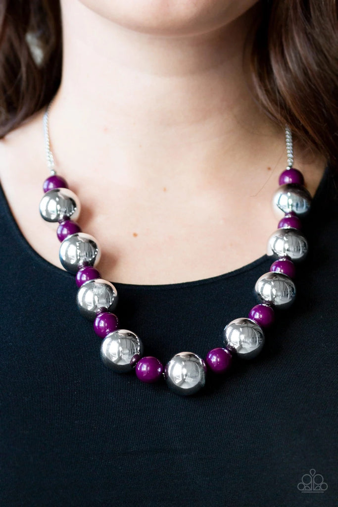 Polished purple beads and dramatic silver beads drape below the collar for a perfect pop of color. Features an adjustable clasp closure.  Sold as one individual necklace. Includes one pair of matching earrings.