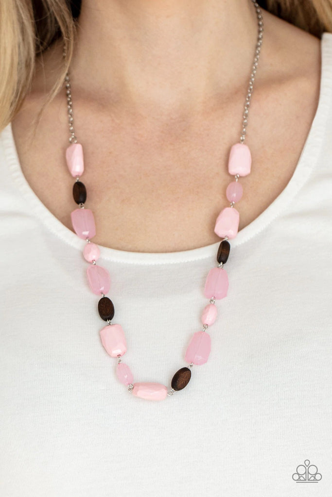 Varying in opacity, a mixed assortment of faceted pink beads delicately link with dainty wooden beads across the chest, creating a whimsically earthy display. Features an adjustable clasp closure.  Sold as one individual necklace. Includes one pair of matching earrings.  