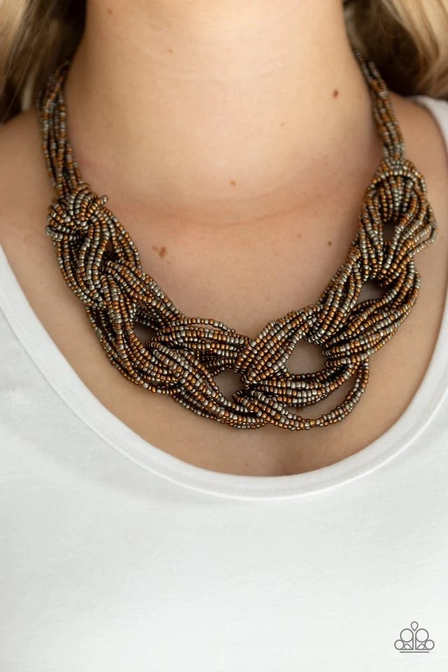 Brushed in a flashy finish, countless strands of copper and gunmetal seed beads weave into a bulky square braid below the collar for a glamorous look. Features an adjustable clasp closure.  Sold as one individual necklace. Includes one pair of matching earrings.  