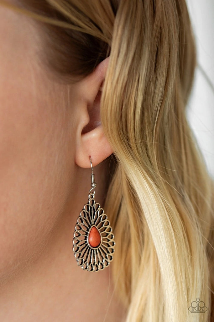 Frilly silver frames flare from the center of a teardrop orange stone, creating a whimsical display. Earring attaches to a standard fishhook fitting.  Sold as one pair of earrings.
