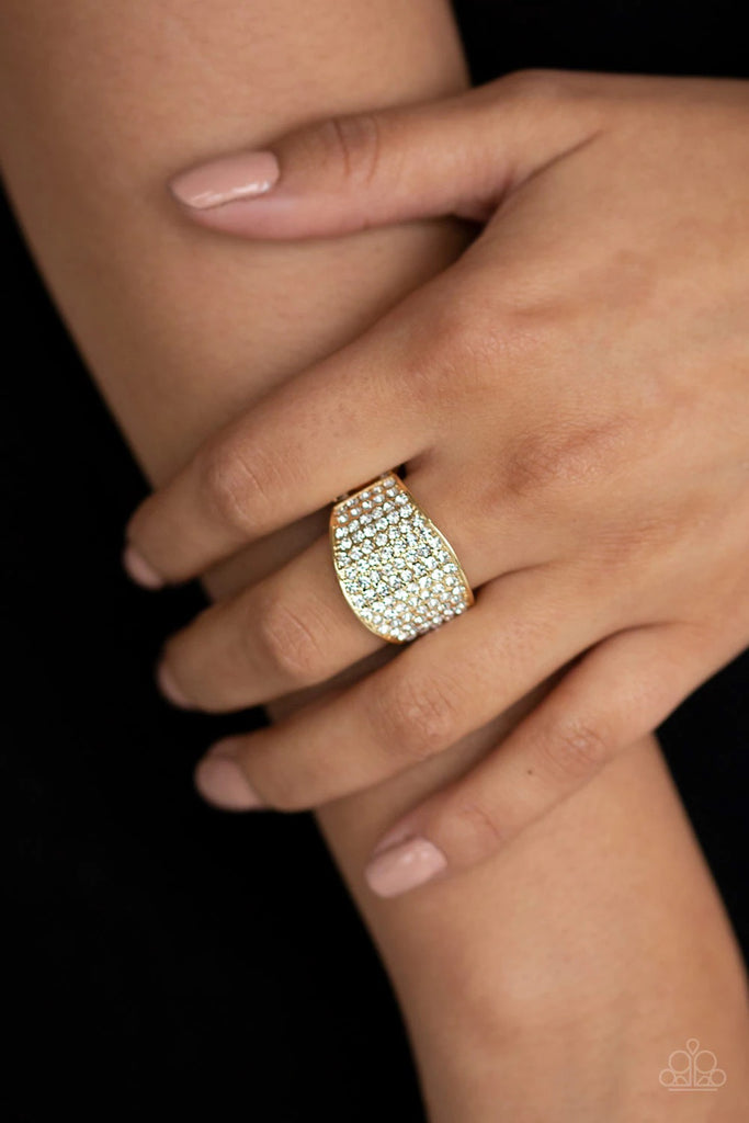 Countless white rhinestones are encrusted along a thick gold band for a spellbinding look. Features a stretchy band for a flexible fit.  Sold as one individual ring.