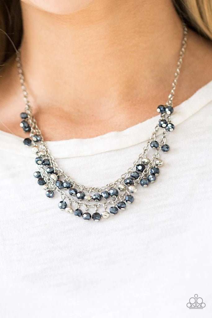 Metallic blue gems and faceted silver beads dangle from two rows of silver chains, creating a glamorous fringe below the collar. Features an adjustable clasp closure.  Sold as one individual necklace. Includes one pair of matching earrings.