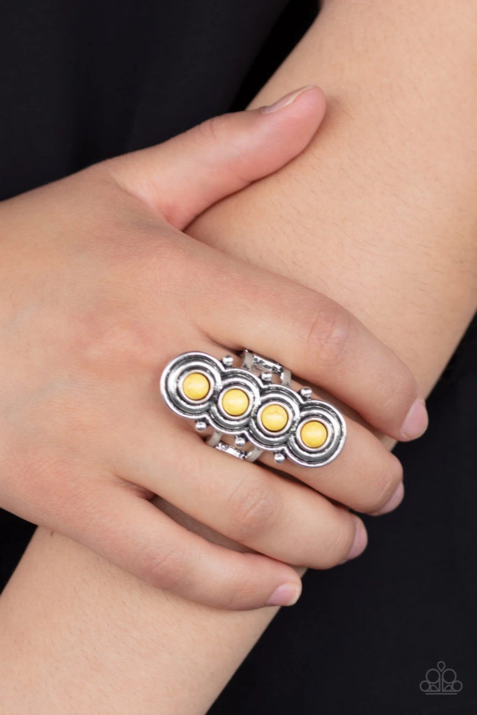 Radiating with antiqued circular frames, a row of dainty yellow stones climb the finger dramatically for a statement-making finish. Features a stretchy band for a flexible fit.  Sold as one individual ring.