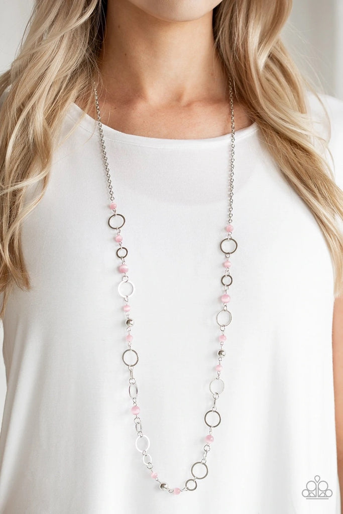 Shimmery silver hoops and glowing pink moonstone beads connect into a whimsical chain across the chest. Features an adjustable clasp closure.  Sold as one individual necklace. Includes one pair of matching earrings.