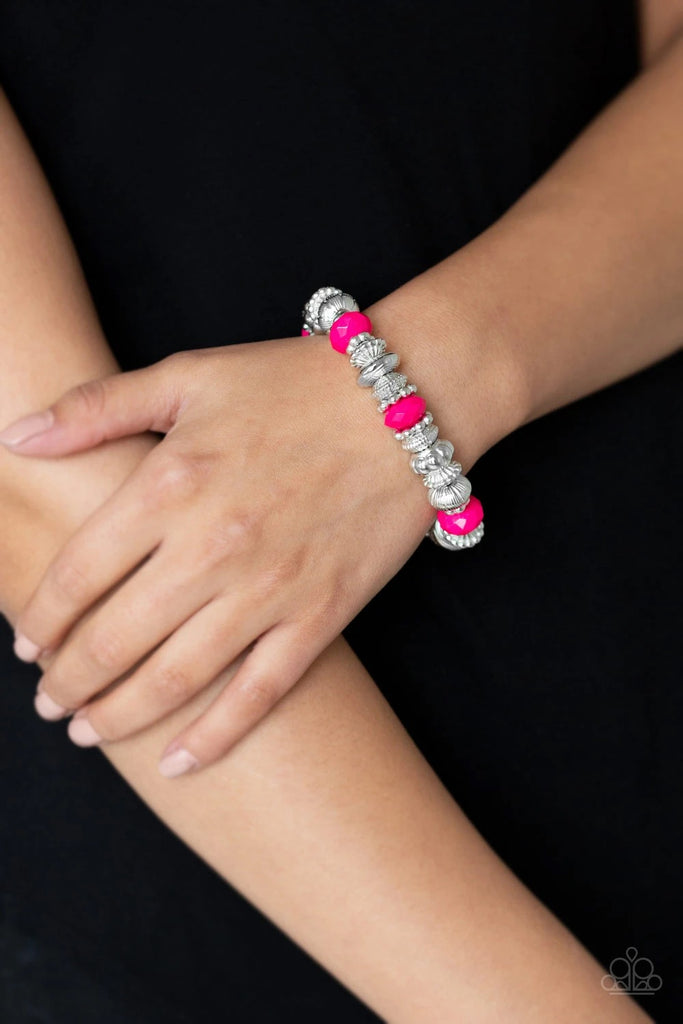 A collection of faceted pink beads, ornate silver beads, and studded silver rings are threaded along a stretchy band around the wrist for a colorfully refined look.  Sold as one individual bracelet.