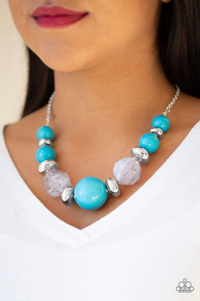 Gradually increasing in size near the center, a collection of blue, silver, and cloudy beads join below the collar in a statement making fashion. Features an adjustable clasp closure.  Sold as one individual necklace. Includes one pair of matching earrings.  