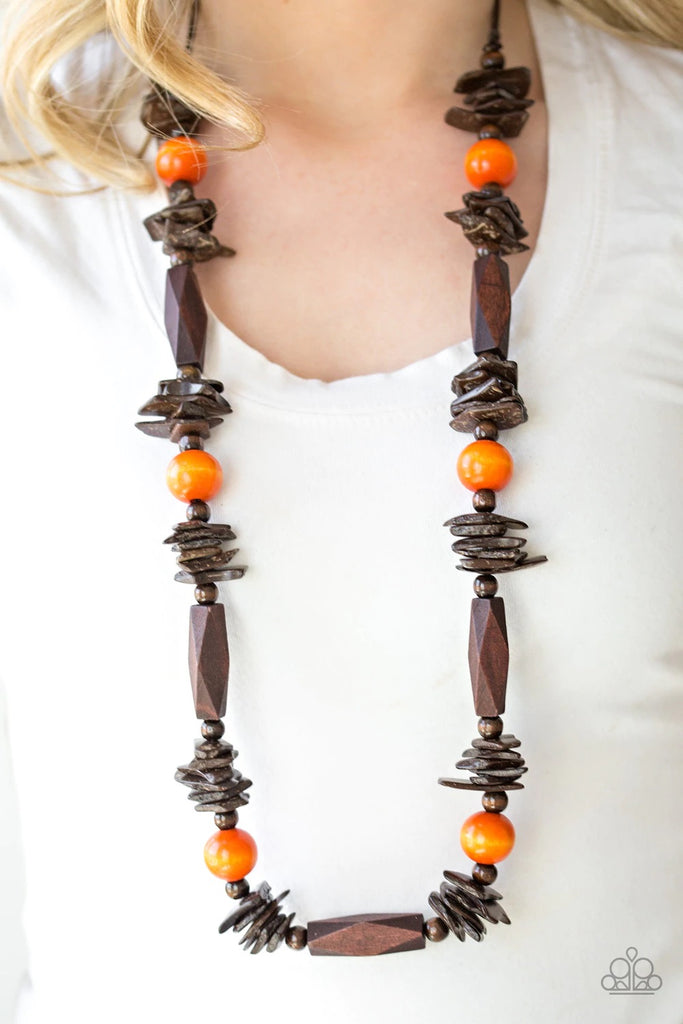 Featuring round, faceted, and distressed finishes, mismatched brown wooden beads are threaded along shiny brown cording. Vivacious orange wooden beads trickle between the earthy accents, adding a colorful finish to the summery palette. Features an adjustable sliding knot closure.  Sold as one individual necklace. Includes one pair of matching earrings.