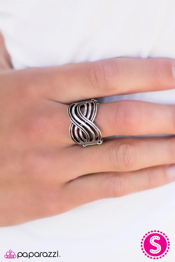 Swirling silver bars crisscross across the finger, joining into a radiant infinity. Painted with antiqued accents, the incandescent design creates an airy band around the finger for a timeless display. Sold as one individual ring.