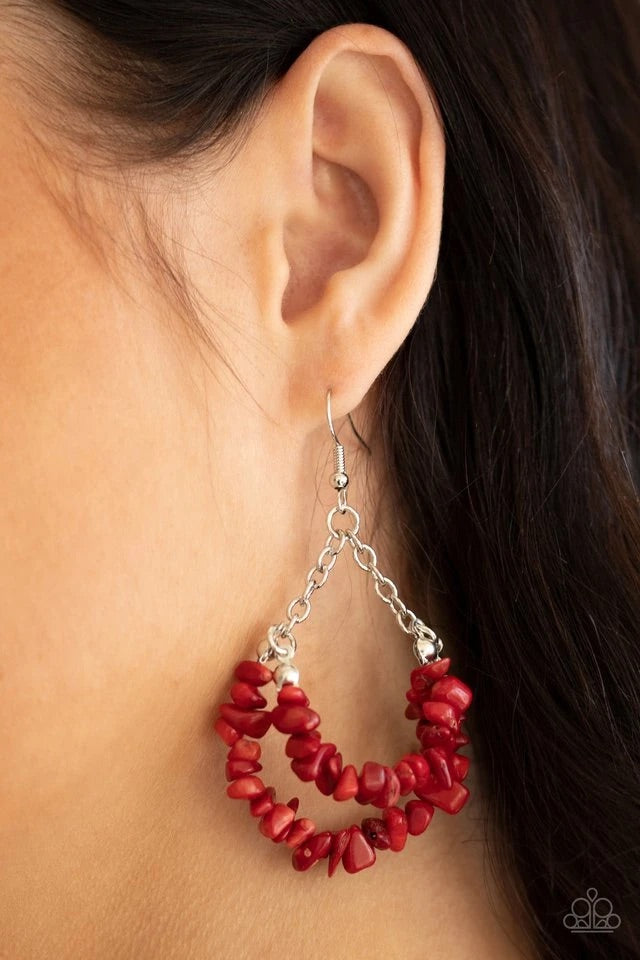 Attached to shimmery silver chains, a fiery collection of red pebble-like stones are threaded along two dainty silver wires, layering into an earthy teardrop. Earring attaches to a standard fishhook fitting.  Sold as one pair of earrings.